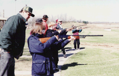 Kds learning to shot a gun.